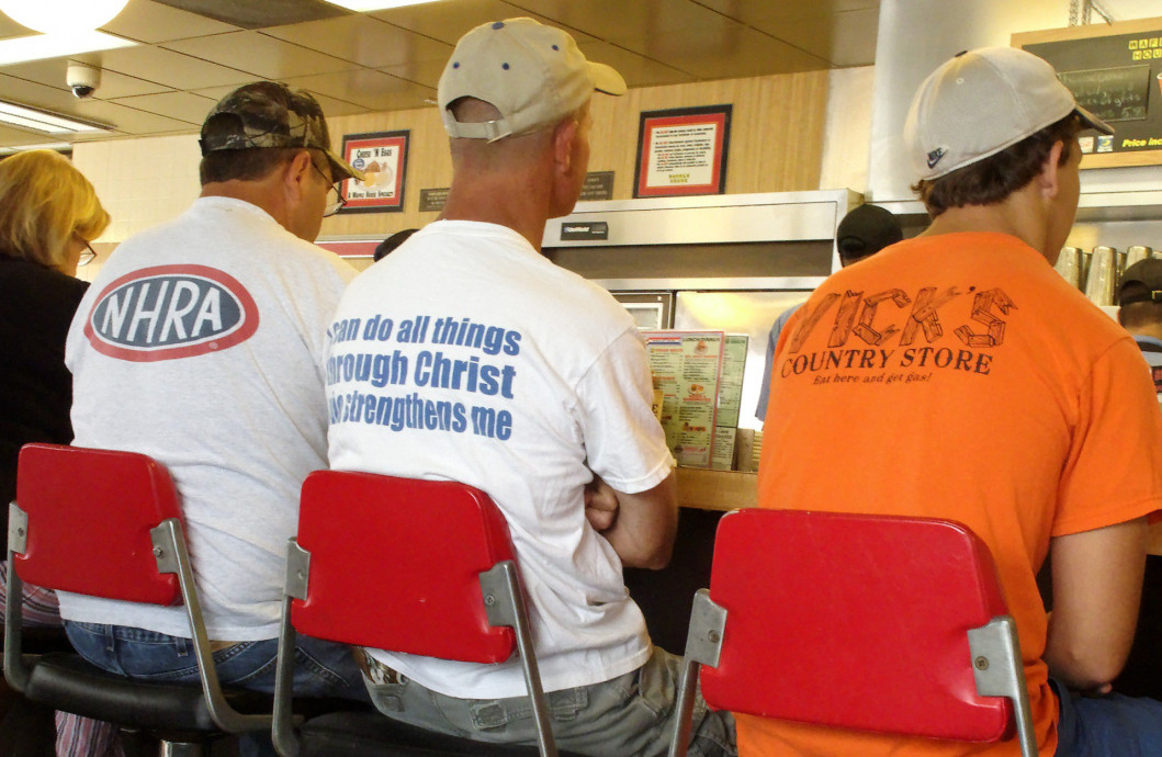 Men wearing tee-shirts in a diner in Gulf Shores, Alabama, 2011