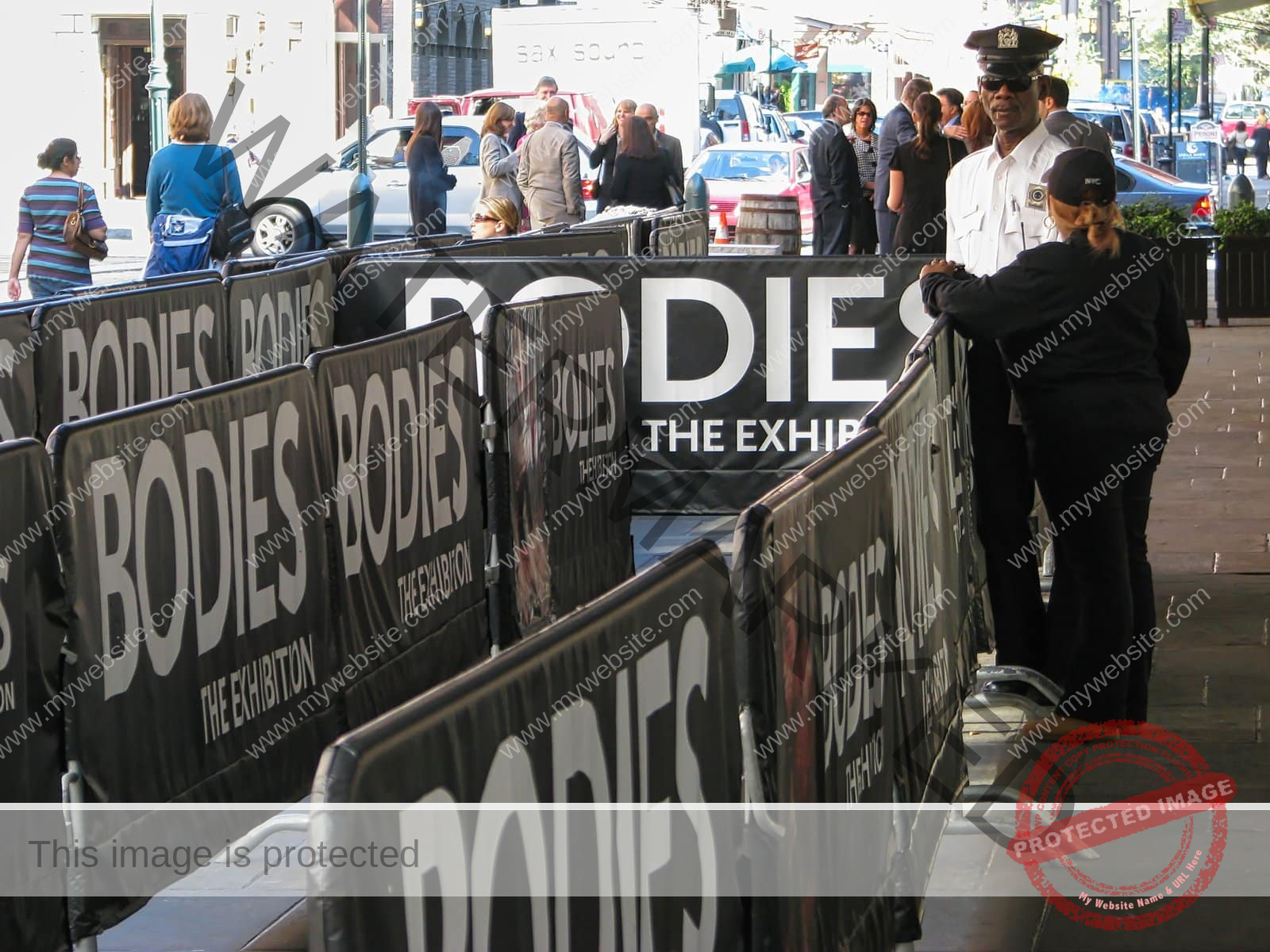 Two NYPD police officers stand guard outside the Bodies Exhibition in New York